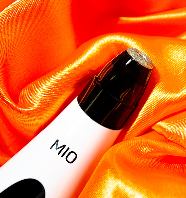 A bottle with the word Spa Sciences on top of an orange fabric.