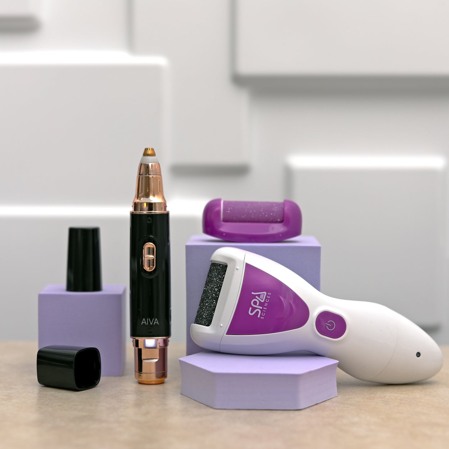 The DARE TO BARE SET by Spa Sciences, featuring electric beauty tools and attachments like a callus remover and facial hair remover, is elegantly arranged on a light surface.