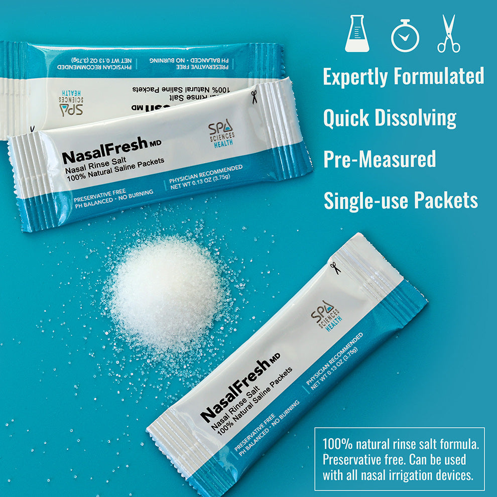 Two blue and white packets labeled "NasalFresh MD Formulated Nasal Rinse Salt" from Spa Sciences are set against a teal background with spilled salt. The text emphasizes benefits such as quick dissolving and a 100% natural nasal wash formula, providing effective sinusitis relief through nasal irrigation.