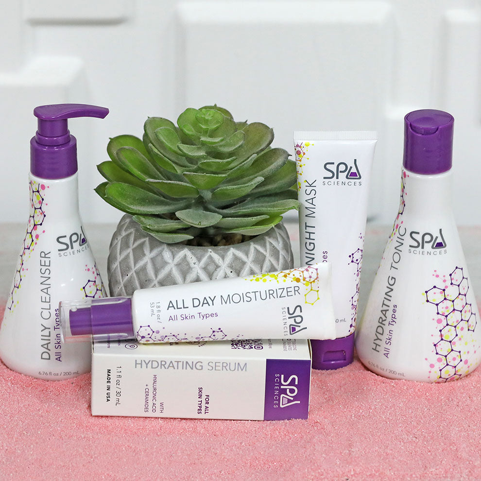 A collection of Spa Sciences products including the Sensitive Skin Starter Pack, arranged around a potted succulent.