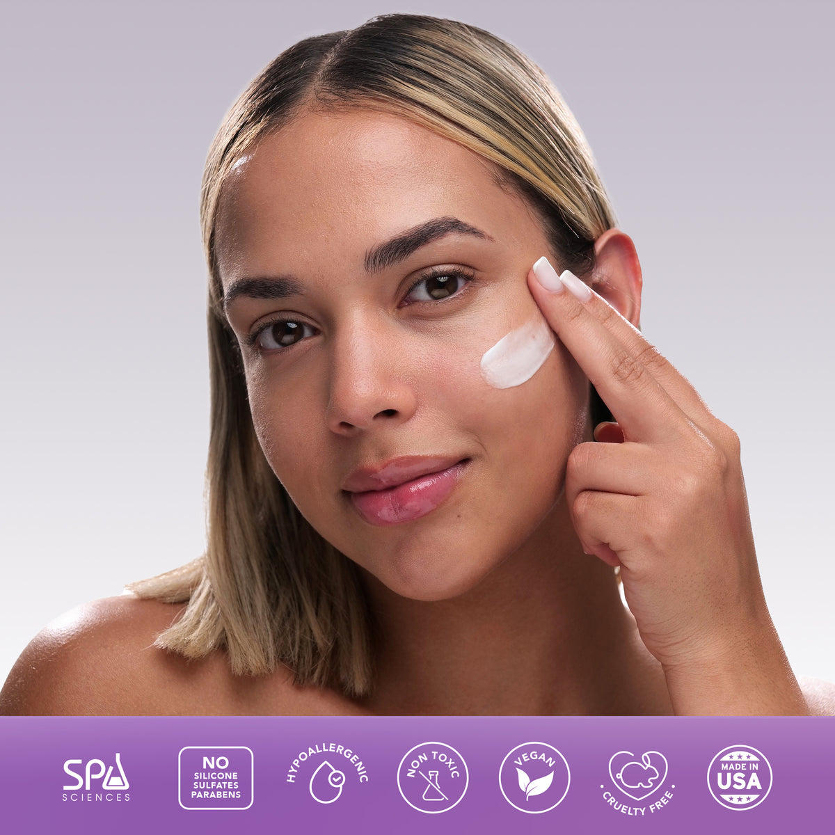 A person applies the Spa Sciences Shine Control System cream to their cheek, with icons indicating it is vegan, cruelty-free, hypoallergenic, non-toxic, free of sulfates, silicones, parabens, and US-made.