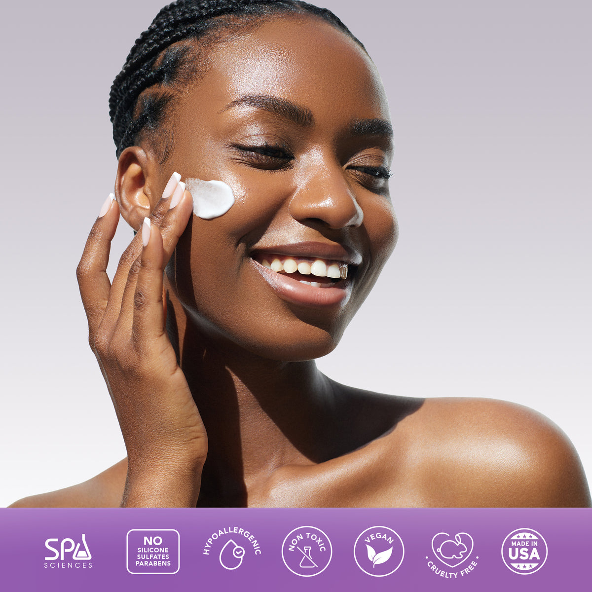 A smiling person applying white cream from the Spa Sciences Skin Cycling Kit (Oily Skin) to their cheek, with a row of product feature icons below.