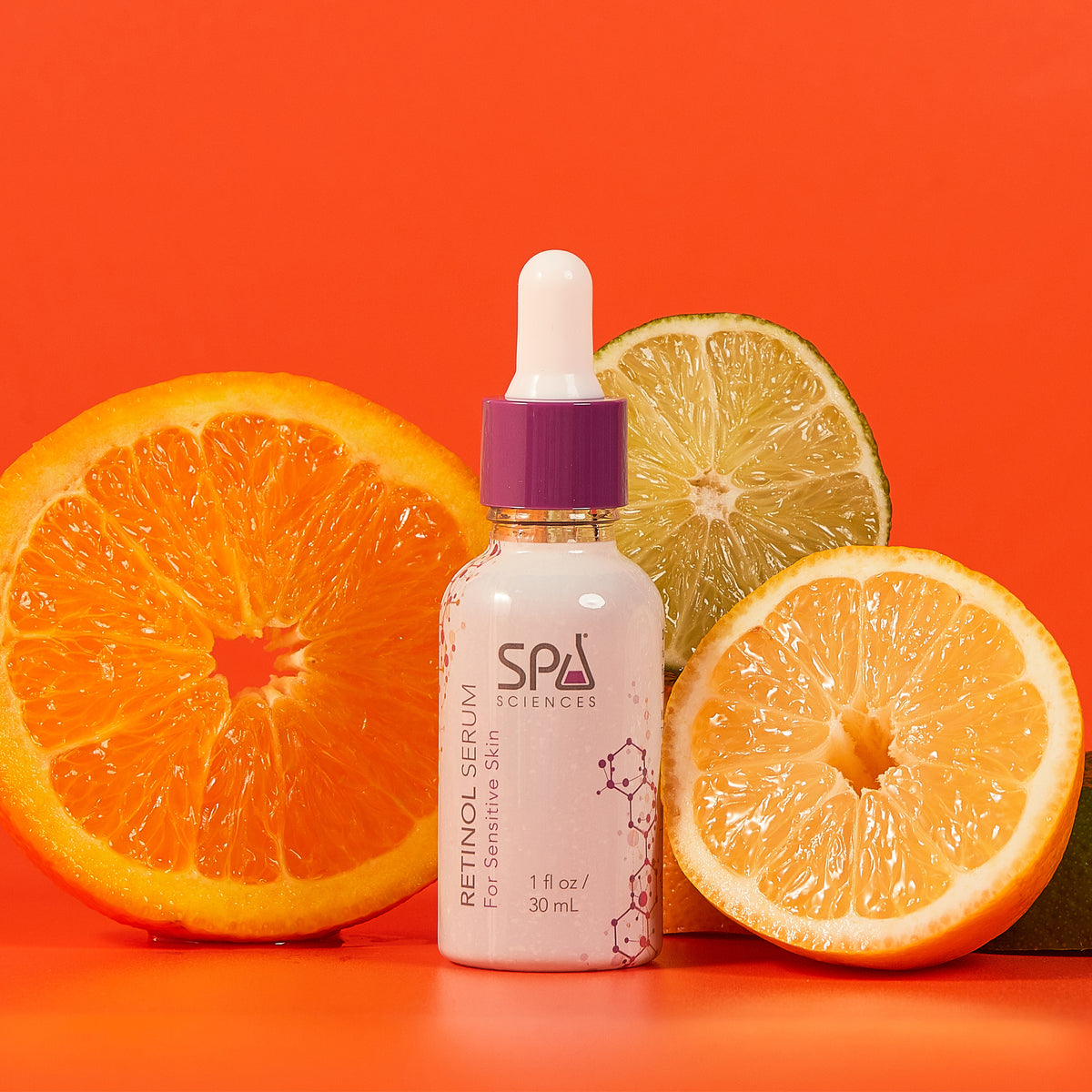 A bottle of Skin Cycling Kit (Oily Skin) retinol serum with a dropper cap, surrounded by slices of orange and lime against an orange background.