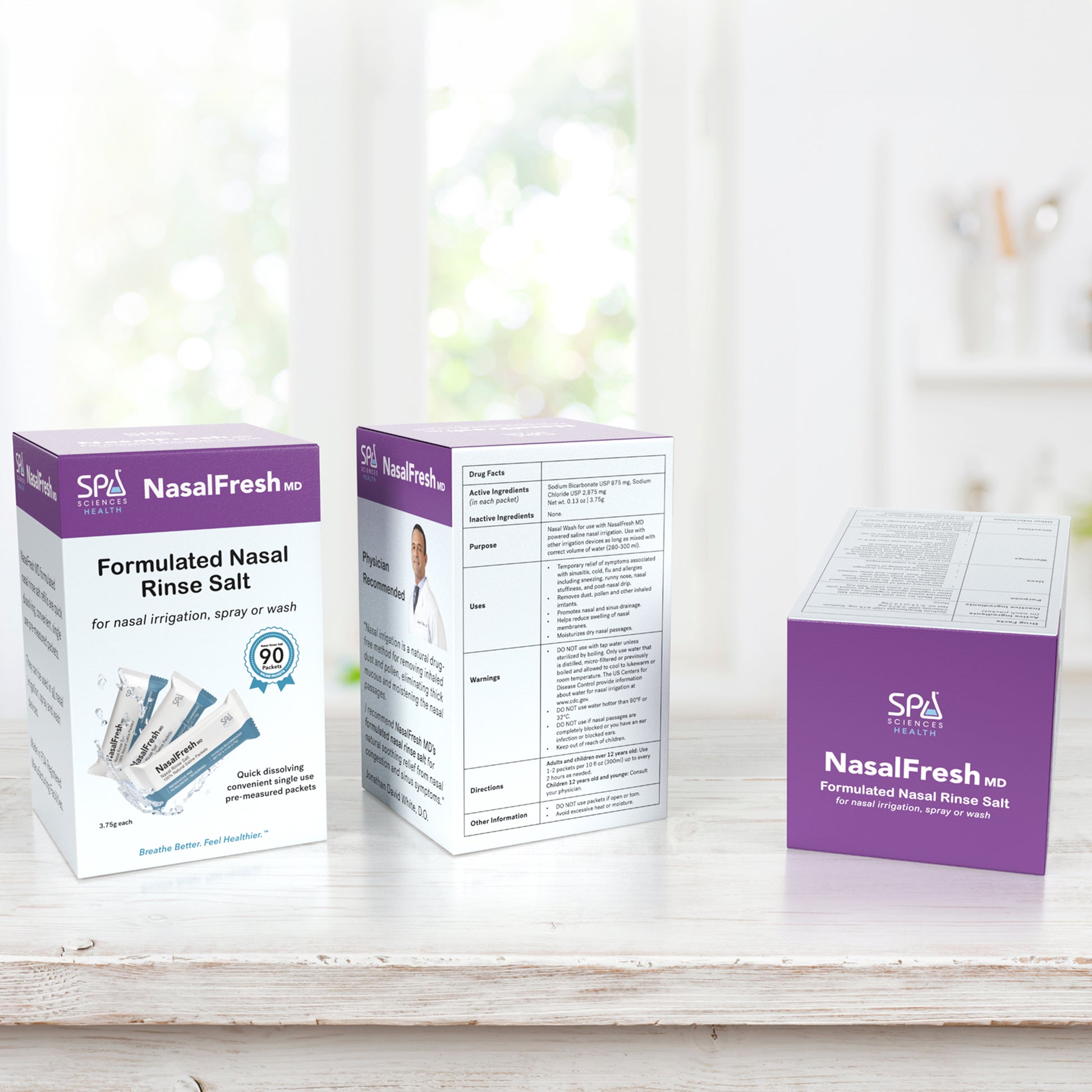 Three boxes of Spa Sciences' NasalFresh MD Formulated Nasal Rinse Salt - 90 Count Refill Packets, ideal for sinus relief, are displayed on a white surface with a blurred background. One box shows the front label, the second displays the side, and the third reveals details perfect for effective nasal irrigation.