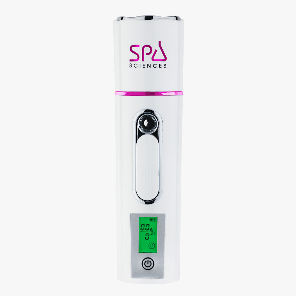 A white handheld NANO MISTER with a pink accent features an LCD screen displaying "00%." The device has a logo that reads "Spa Sciences" and a power button at the bottom.