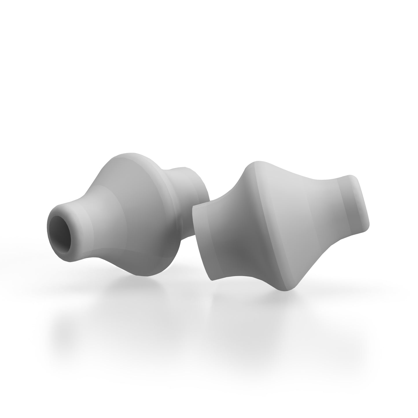 On a white surface lies a pair of gray, cone-shaped objects with hollow centers, designed as fully compatible replacement nose pillows for the NasalFresh MD device. These are the Pair of Replacement Nose Pillows by Spa Sciences.