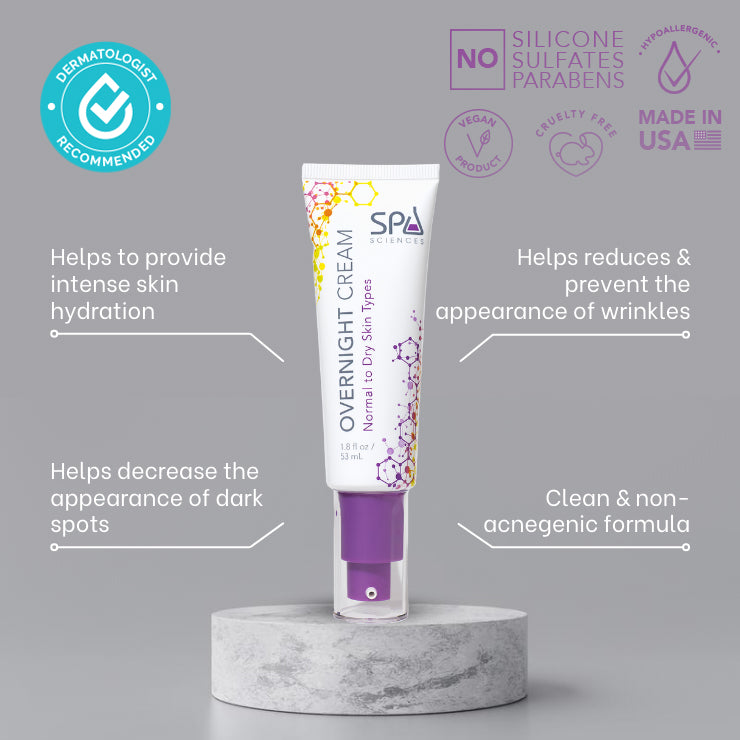 A tube of Spa Sciences Overnight Cream Dry Skin with ingredients on top of a luxurious marble table to target signs of aging and maintain moisture levels.
