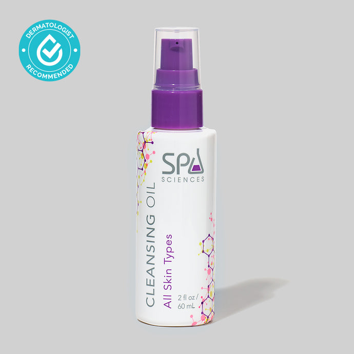 A bottle of Spa Sciences Cleansing Oil for makeup removal on a grey background.