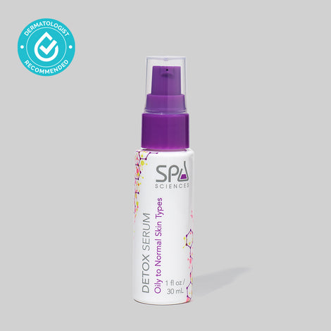 A bottle of Spa Sciences Detox Serum with a purple spray for clear skin on a grey background.