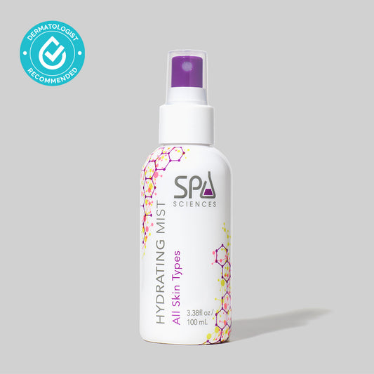 A Spa Sciences hydrating mist bottle on a grey background, filled with antioxidants for skin radiance.