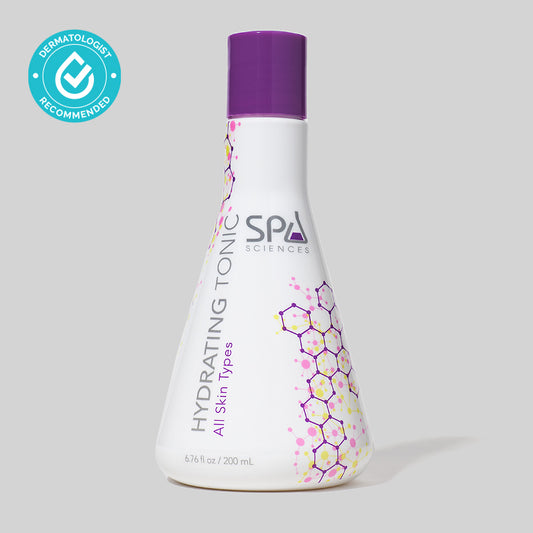 A bottle of Spa Sciences Hydrating Tonic with botanical extracts in a purple bottle on a grey background.