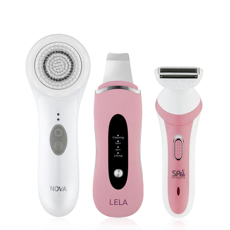 A pink and white FLAWLESS GLOW SET electric shaver from Spa Sciences sits on a white surface, perfect for your skincare routine.