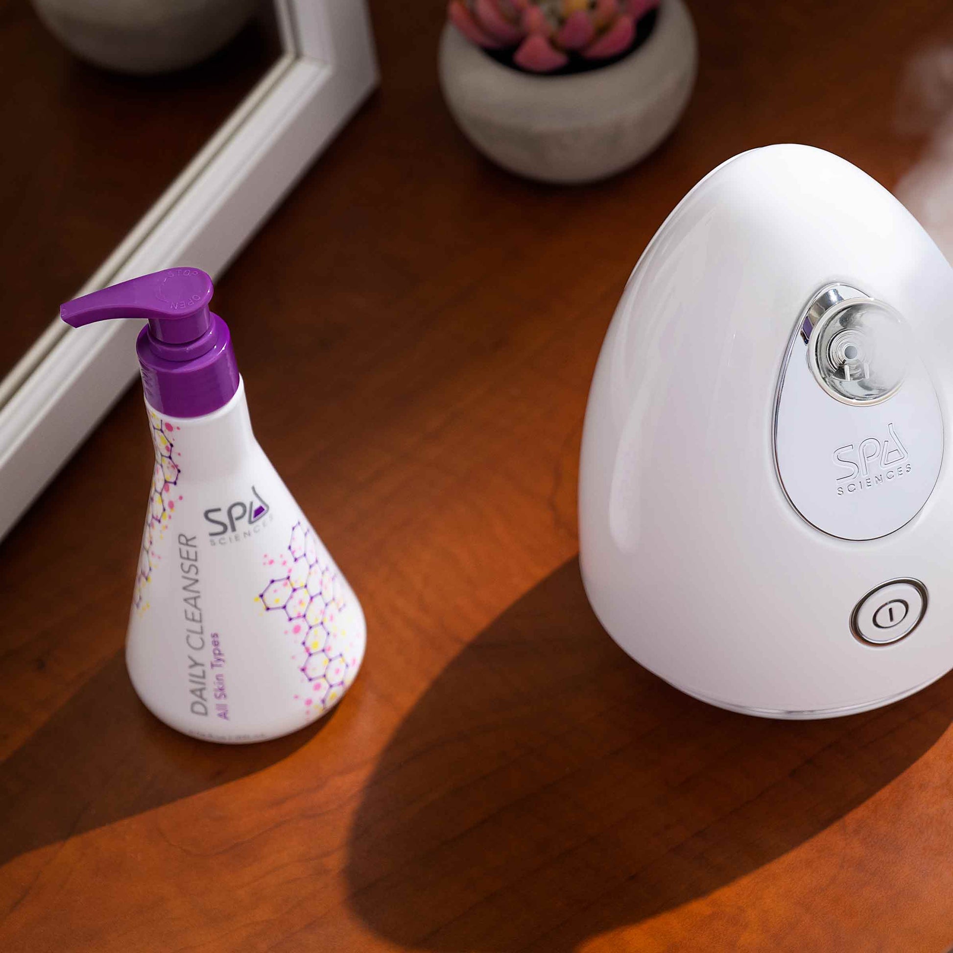 A hydrating humidifier next to a Spa Sciences Daily Cleanser helps cleanse the skin and remove impurities.