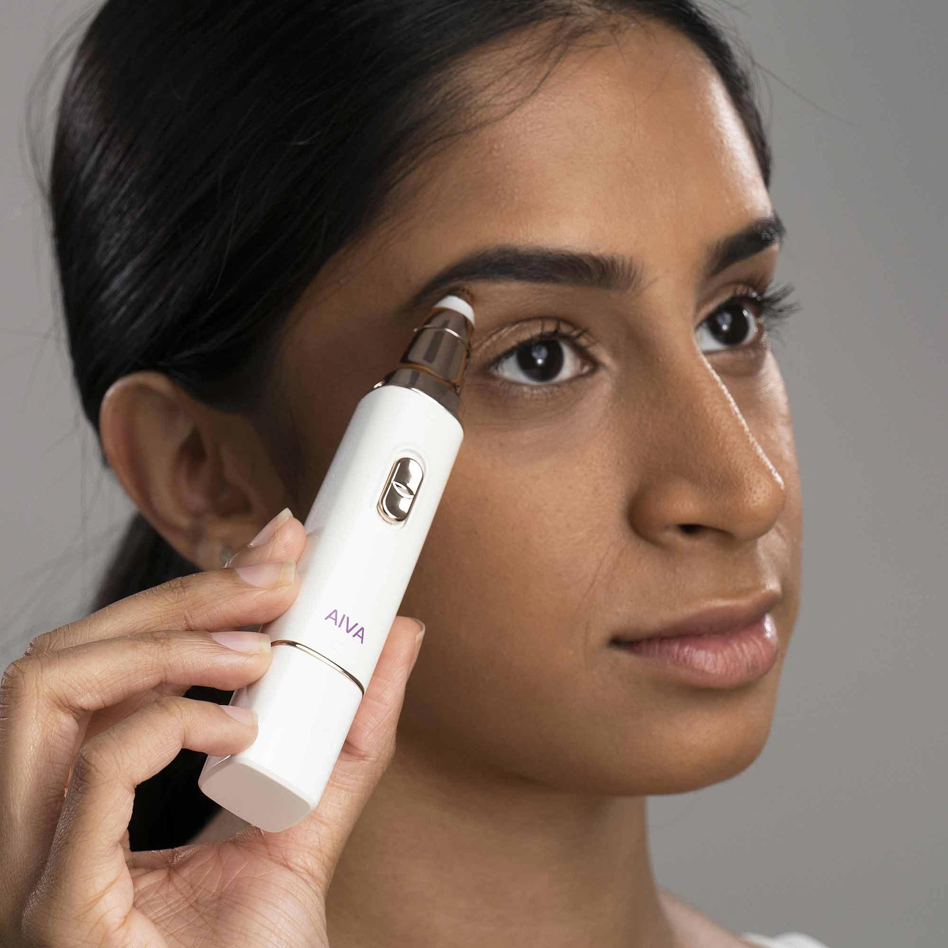 A woman is using Spa Sciences Eyes & Lips on her face.