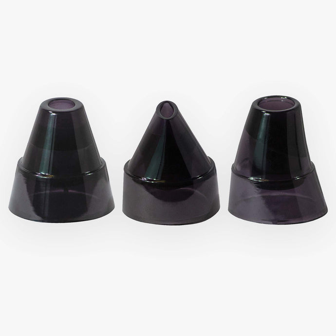 Three black glass cones on a white surface, used as replacement pore extraction tips for the Spa Sciences MIO Device.