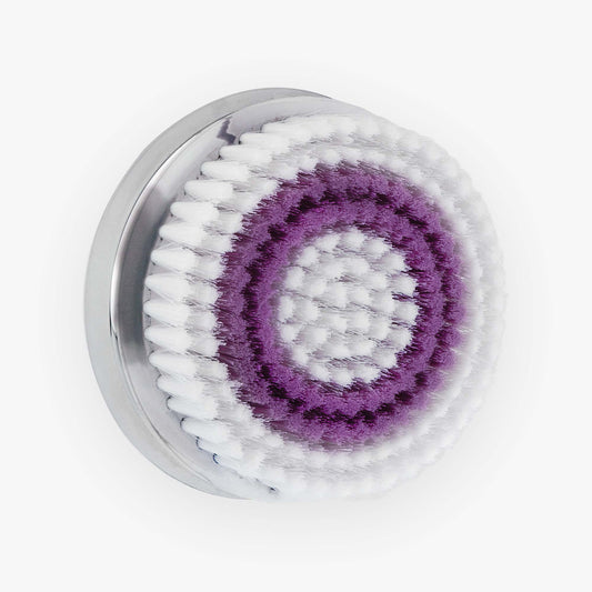 A purple and white circular NERA Replacement Body Brush Head by Spa Sciences on a white surface.