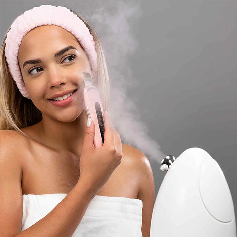 The woman is using a Spa Sciences 'Perfect Pores' Set to steam her face.
