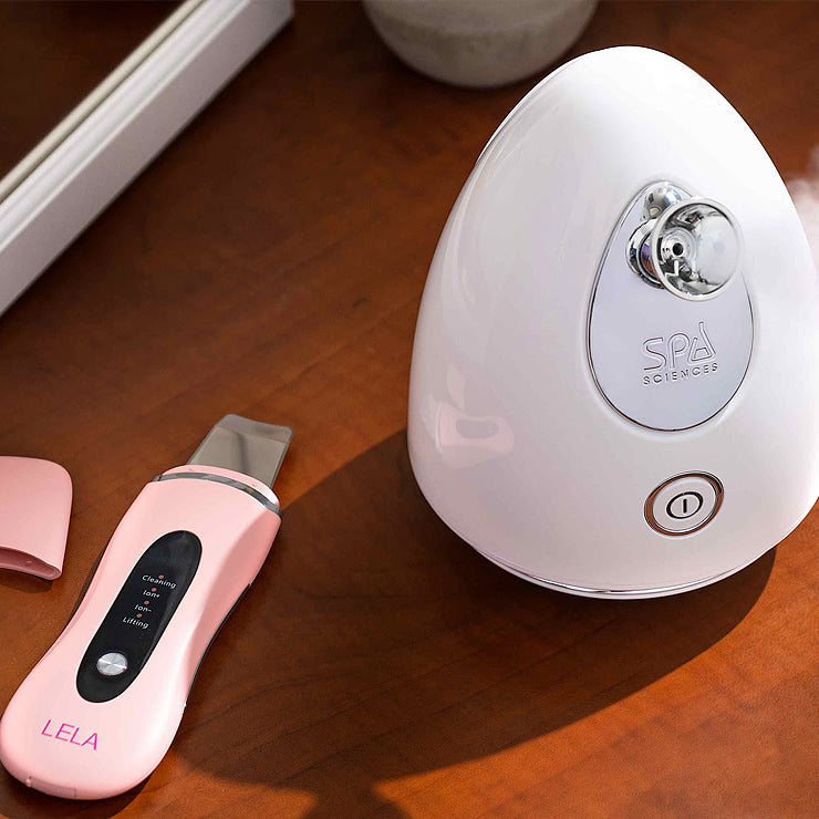A pink Perfect Pores Nano Ionic Facial Steamer by Spa Sciences is placed on a desk for Facial Cleansing.
